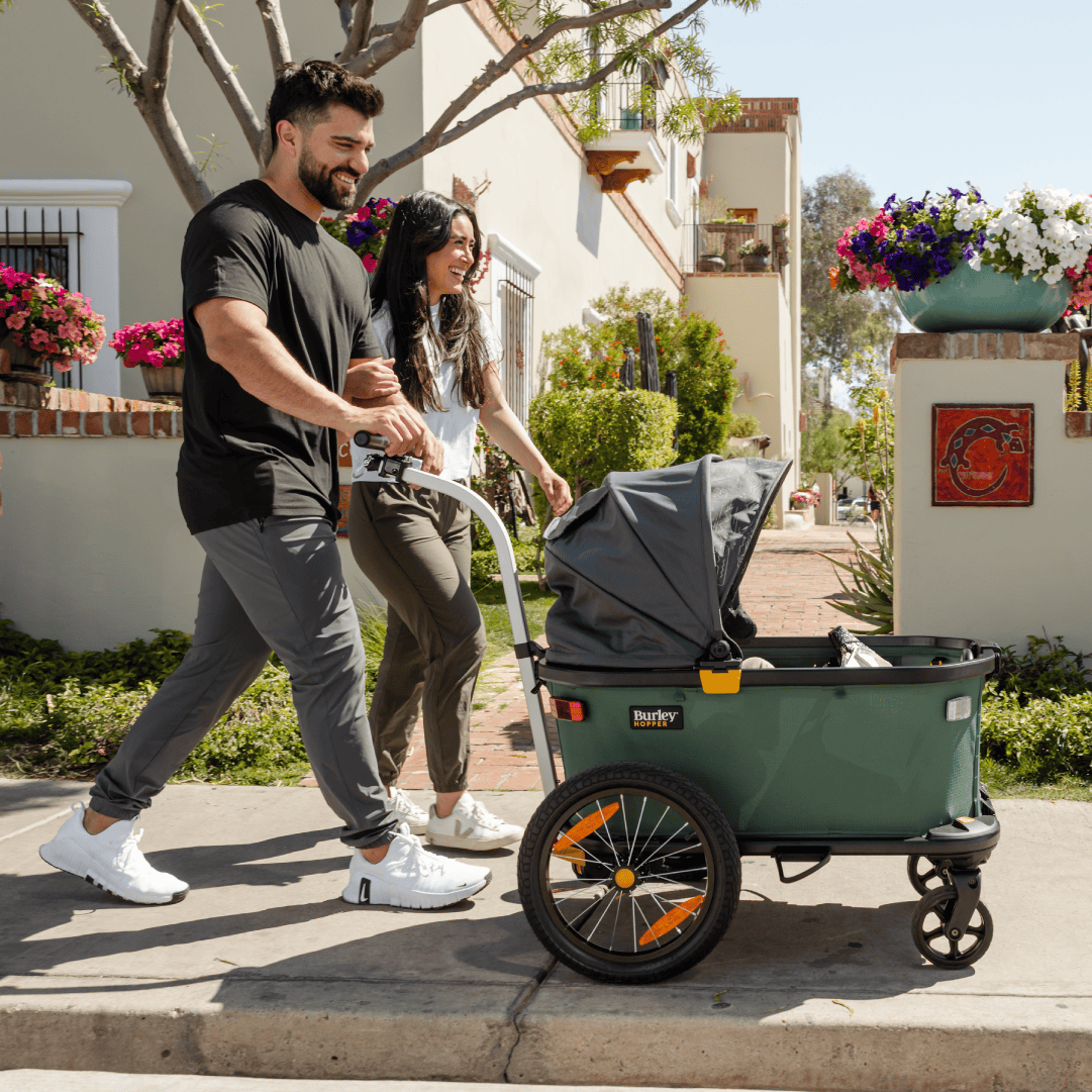 A Burley cargo trailer carrying goods through a neighborhood